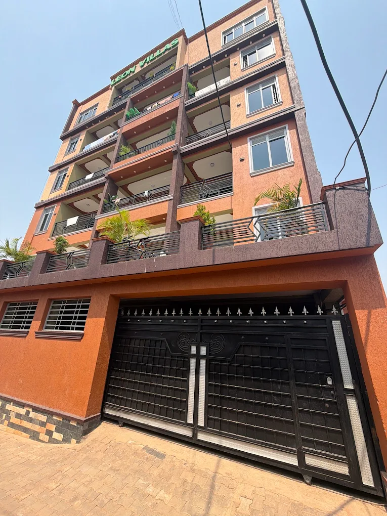 The black steel entrance gate at street level, with balconies above